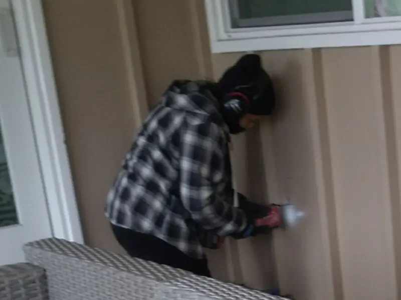 Professional electrician installing an exterior outlet in Deerfield