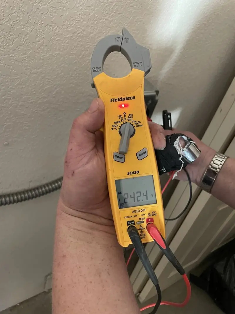 Voltage testing with clamp meter during Outlet Installation in Deerfield